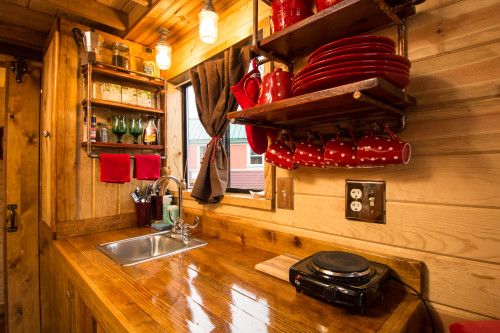To save counter space, the Caboose kitchen has built-in shelves for storing dishes and spices.