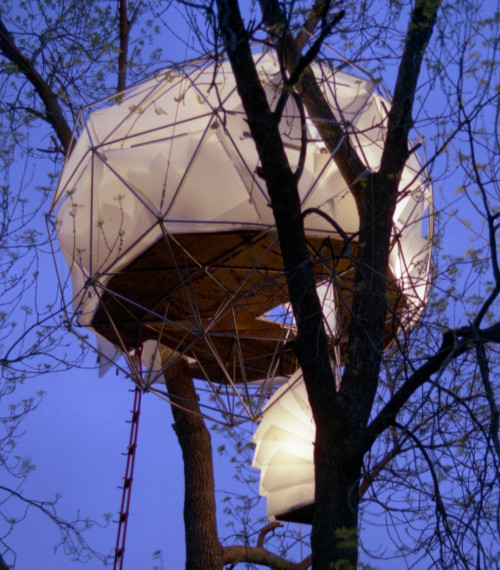 The Leaf House by O2 Treehouse is dubbed the 'floating lantern' because of its striking silhouette against the night sky.