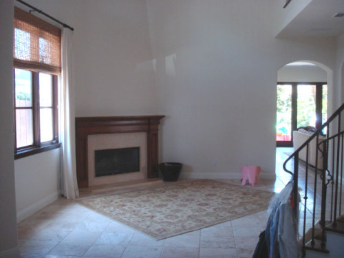 Before: The living room's short fireplace and mantle appeared to be “stuck on the wall.”