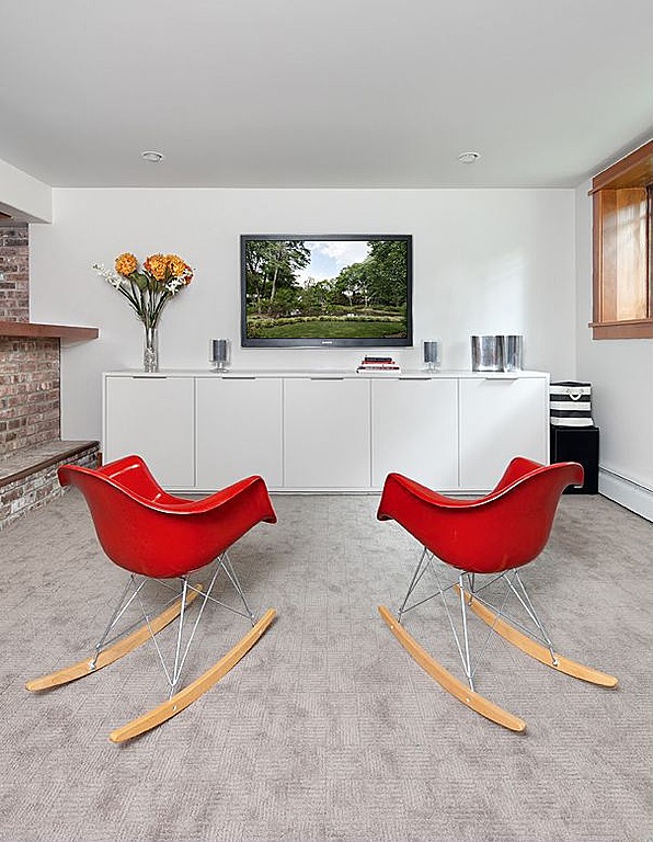 Red Eames-like chairs pop in this neutral space.