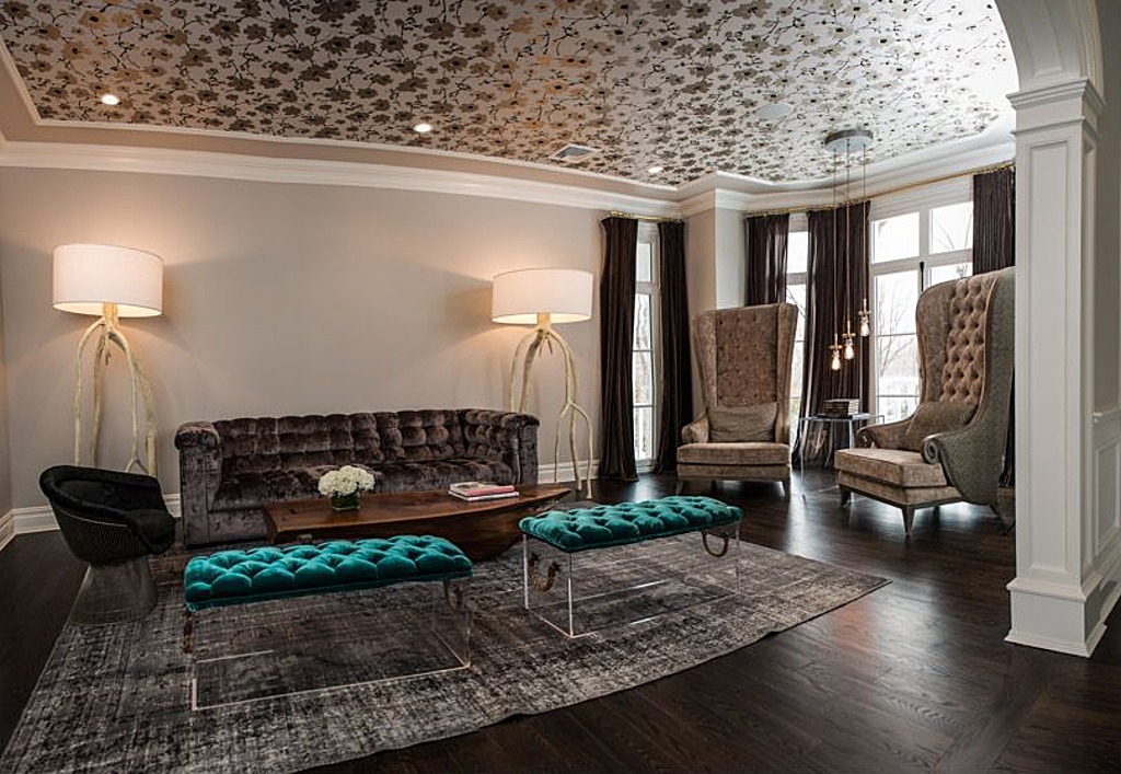 The ceiling features a gold print, but the legs of the coffee table are silver.