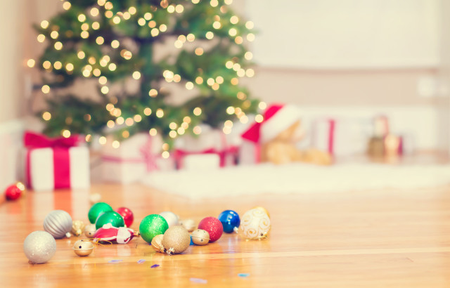 Christmas tree and Christmas ornaments on floor