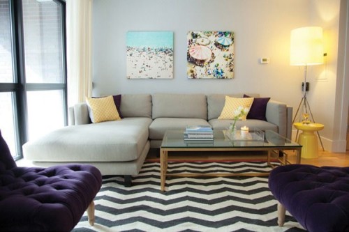 Loveseats in a deep plum pairs with yellow pillows and accents. Photo by NinaStyling.