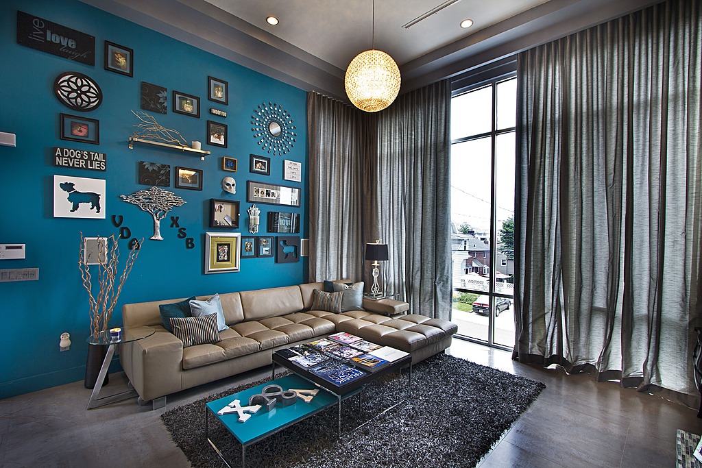 A bright jade statement wall livens up the living room by Vanessa DeLeon Associates.