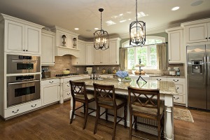 Typically traditional kitchens have white cabinets with detailed molding, vintage drawer pulls or other antique hardware, marble or light-colored granite counters, crown molding, dark wood floors and wainscoting.